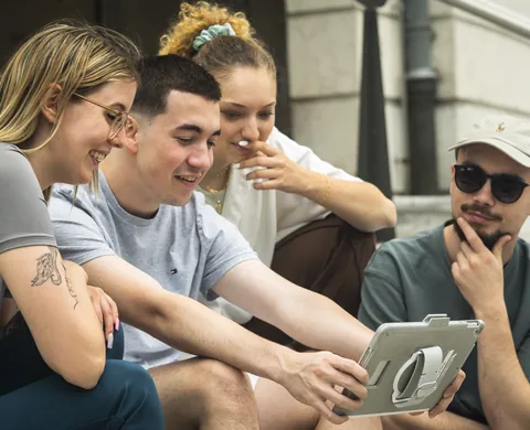 Four players with the tablet on the steps