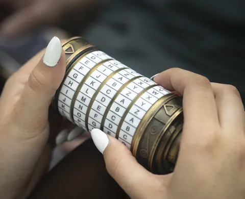 Hands turning a cryptex