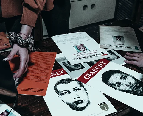 Team examining wanted posters and clues