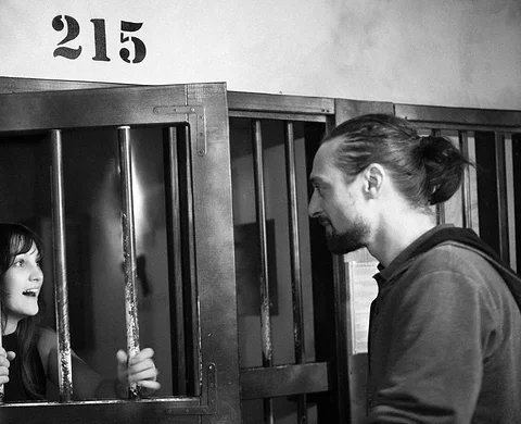 Team at the barred door of cell 215