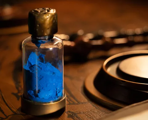 Vial of blue potion on the wooden table